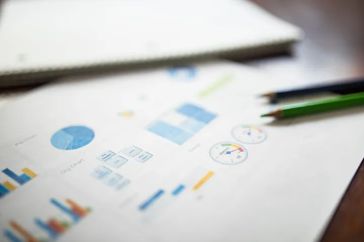 Retirement income charts and planning documents on a desk